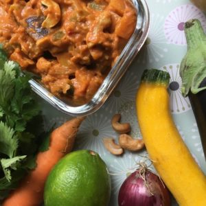 Un plat de légumes curry, coco, cajou et une carotte, une aubergine, une courgette, de la coriandre, etc.